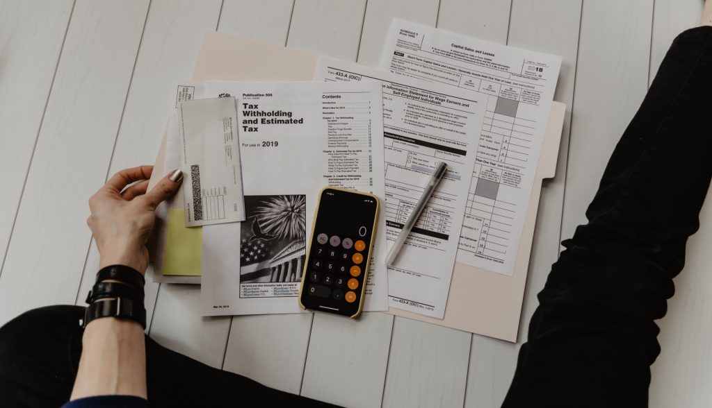 A person sitting on the floor with documents in front