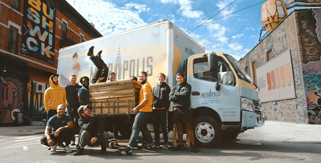 Professional movers standing in front of a truck