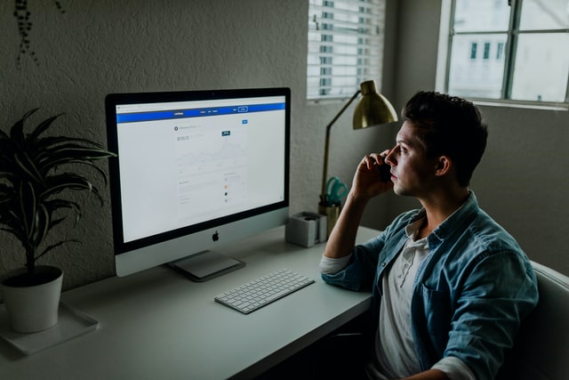 A man looking at a computer screen