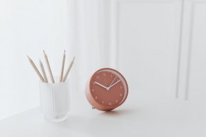 Red clock on table