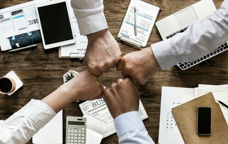 Hands fistbumping after starting a family business in Lakewood.