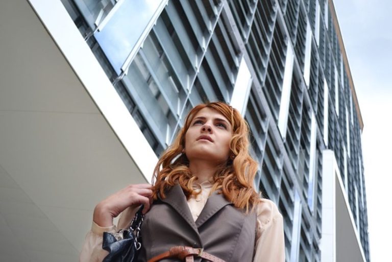 A woman in front of a business building.